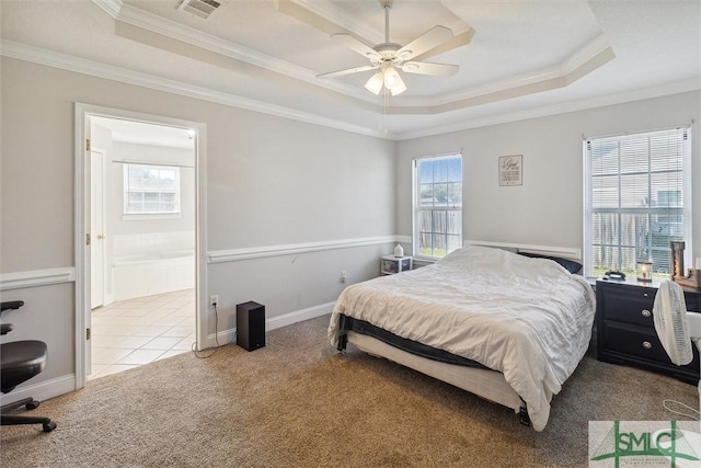 bedroom with multiple windows, ceiling fan, and light colored carpet