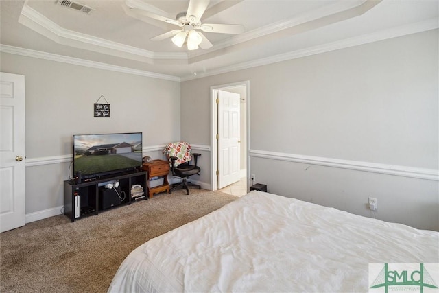 bedroom featuring a tray ceiling, ceiling fan, and crown molding