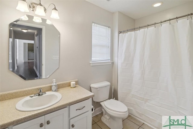 bathroom featuring tile patterned floors, curtained shower, vanity, and toilet