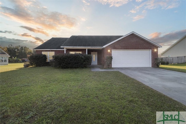 view of front of property featuring a yard and a garage