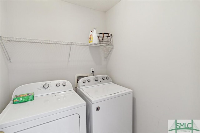 clothes washing area with washer and dryer