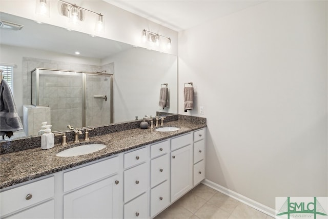 bathroom with vanity, a shower with shower door, and tile patterned flooring