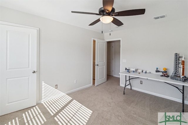 interior space with light carpet and ceiling fan