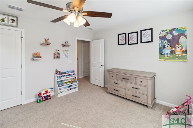 rec room featuring light carpet and ceiling fan