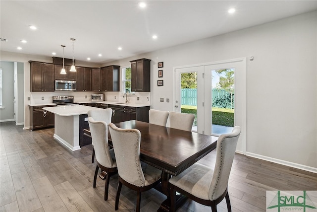 dining area with wood-type flooring and sink