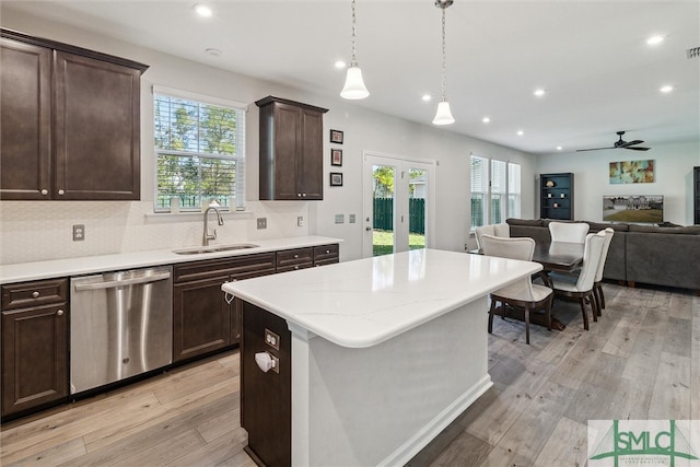 kitchen featuring light hardwood / wood-style flooring, dishwasher, sink, and plenty of natural light