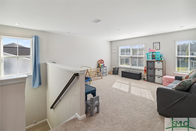 carpeted living room featuring plenty of natural light