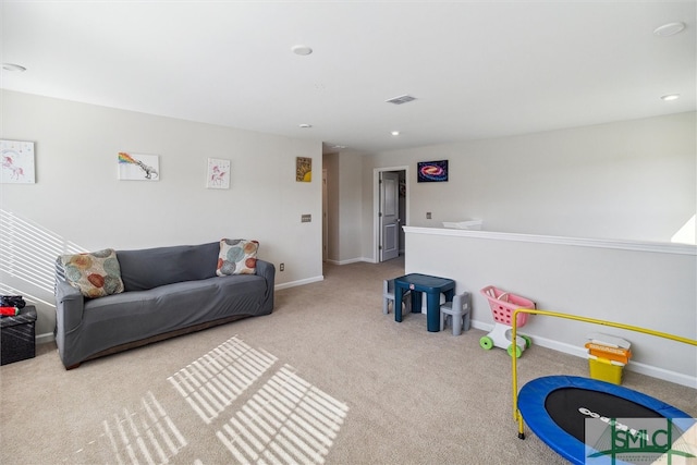 recreation room with light colored carpet