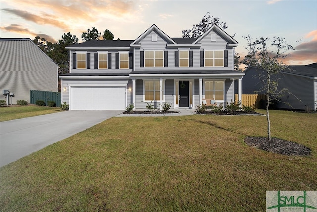 view of front of property with a lawn and a garage