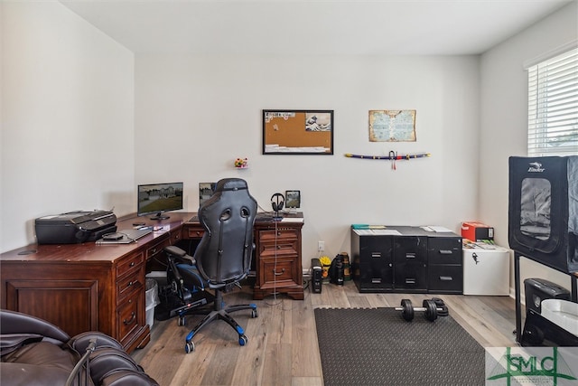 office area with light hardwood / wood-style floors