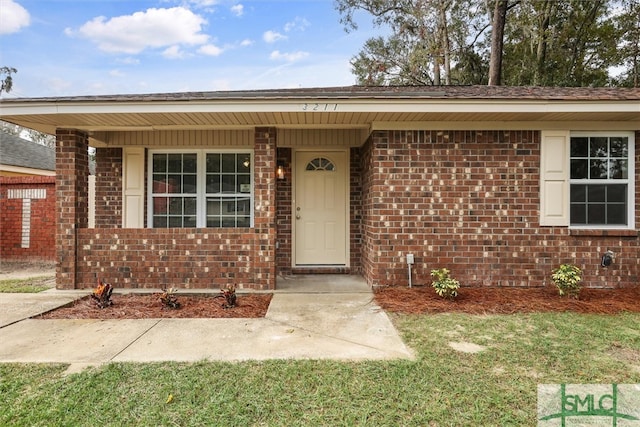 view of exterior entry with covered porch