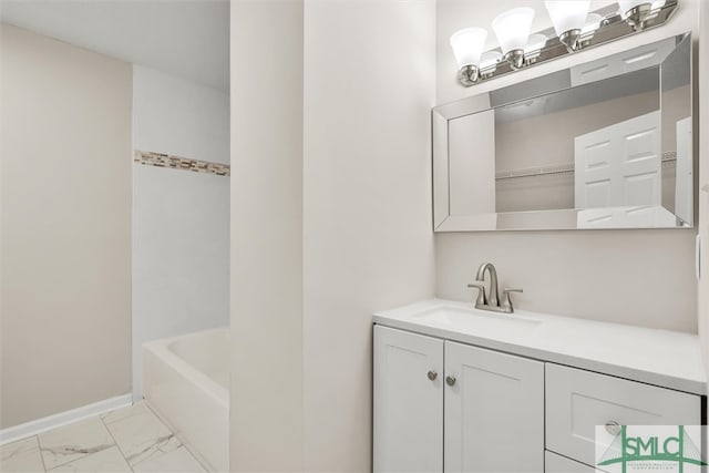 bathroom featuring a washtub and vanity