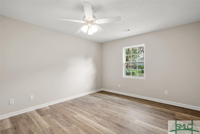 empty room with ceiling fan and light wood-type flooring