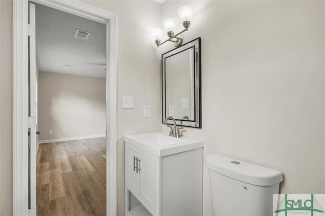 bathroom with vanity, hardwood / wood-style floors, toilet, and a textured ceiling