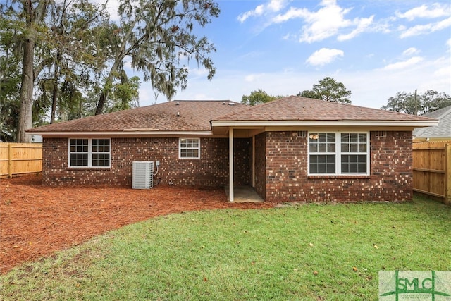 back of property featuring a yard and cooling unit