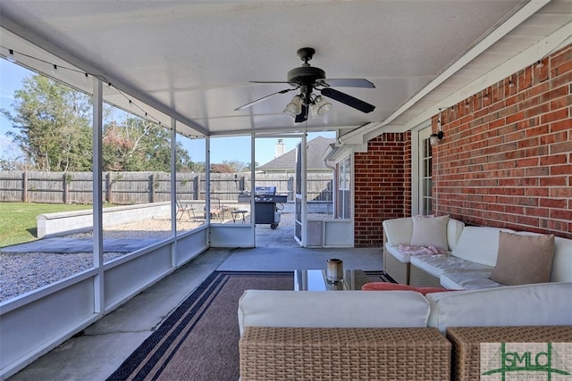 unfurnished sunroom featuring ceiling fan