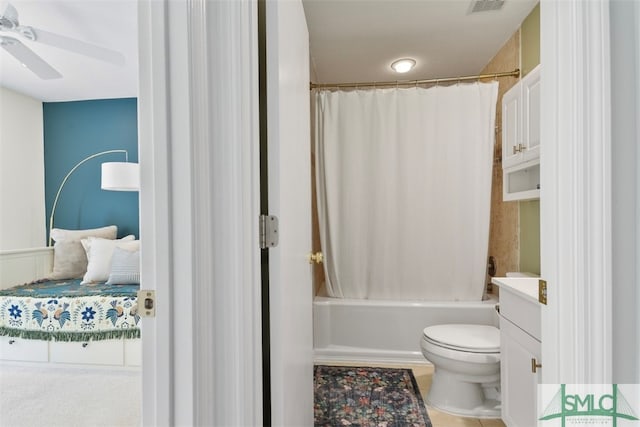 full bathroom featuring ceiling fan, shower / bathtub combination with curtain, tile patterned floors, toilet, and vanity