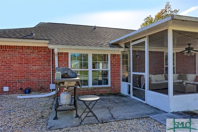 back of property featuring a sunroom, ceiling fan, and a patio