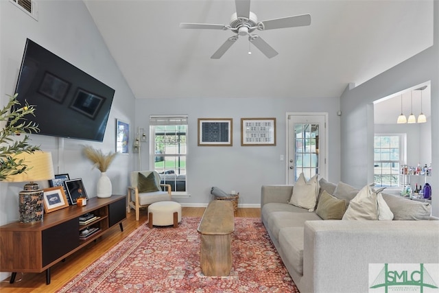 living room featuring hardwood / wood-style flooring, plenty of natural light, lofted ceiling, and ceiling fan