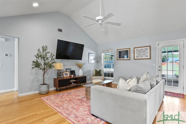 living room with hardwood / wood-style flooring, a wealth of natural light, and ceiling fan