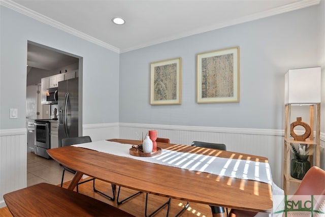 dining space featuring light tile patterned floors and ornamental molding