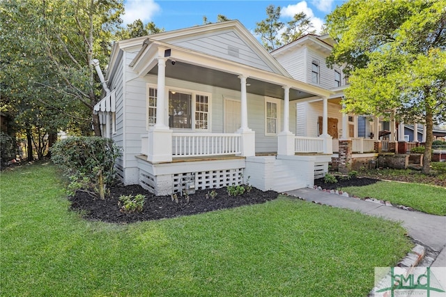 view of front of home with covered porch and a front lawn