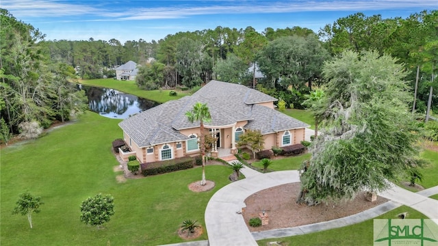 view of front of home with a front lawn and a water view