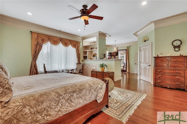 bedroom with ornamental molding, ceiling fan, and wood-type flooring