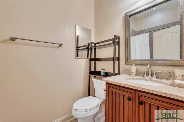 bathroom with vanity, toilet, and curtained shower