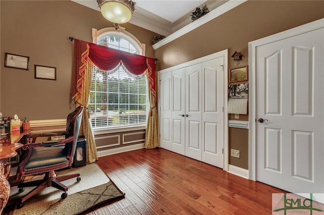 office area with hardwood / wood-style flooring and crown molding