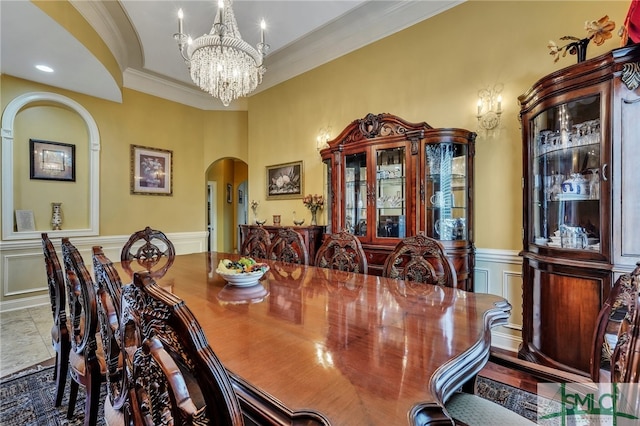 dining area featuring a chandelier and ornamental molding