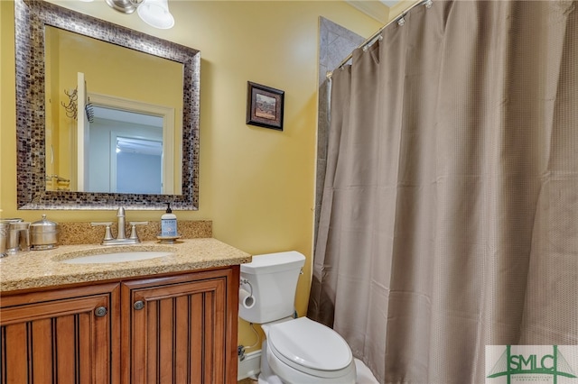 bathroom featuring vanity, toilet, and a shower with shower curtain