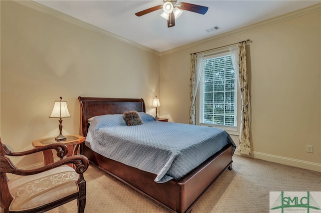 carpeted bedroom with ceiling fan and crown molding