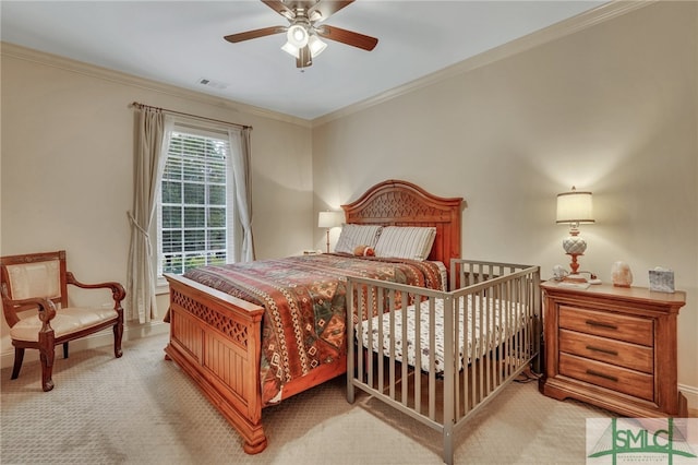 carpeted bedroom with ceiling fan and crown molding