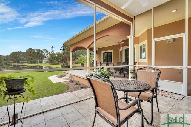 view of patio / terrace featuring ceiling fan and a water view