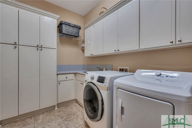 laundry room with separate washer and dryer, sink, light tile patterned floors, and cabinets