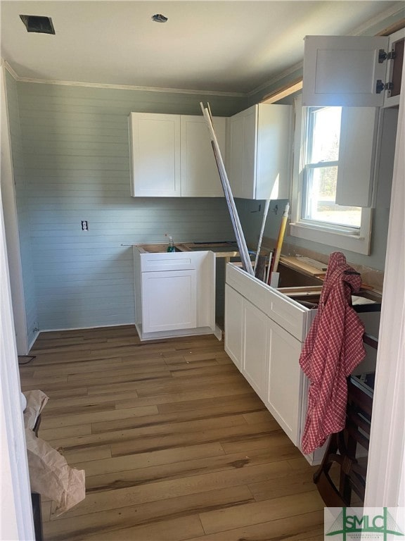 kitchen featuring hardwood / wood-style floors and white cabinetry