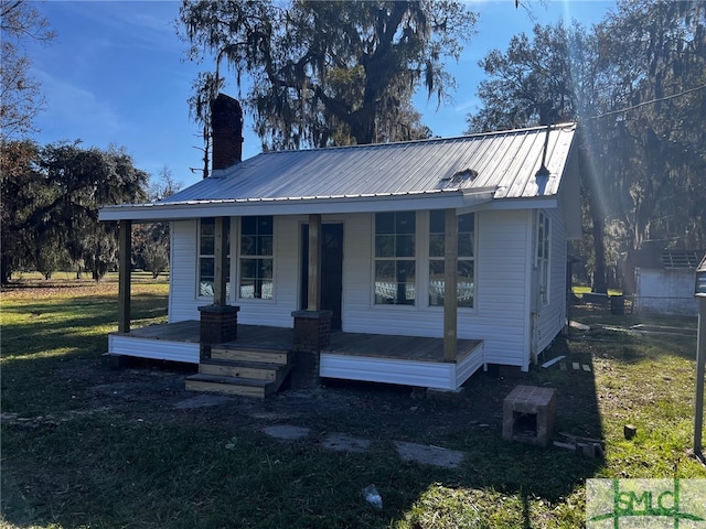 bungalow-style home with covered porch and a front yard