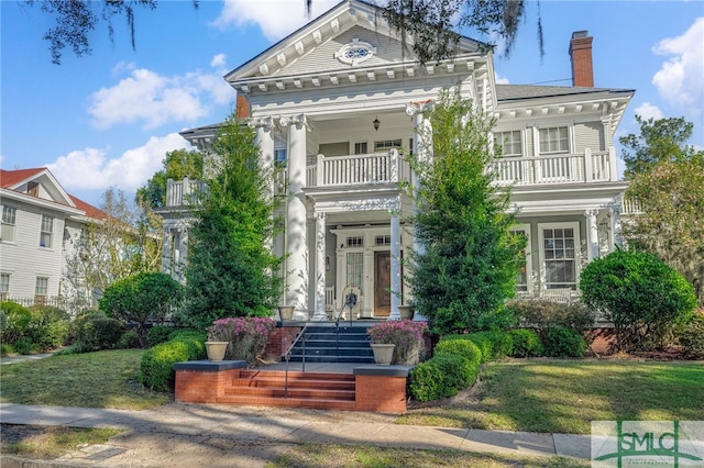 18 E 34th St, Savannah, GA 31401 - greek revival inspired property featuring a balcony, a chimney, and a front yard