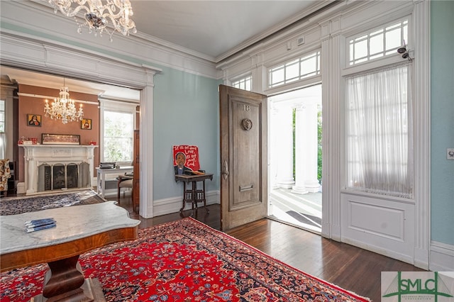 18 E 34th St, Savannah, GA 31401 - entryway featuring a chandelier, dark wood-type flooring, ornamental molding, a fireplace, and baseboards