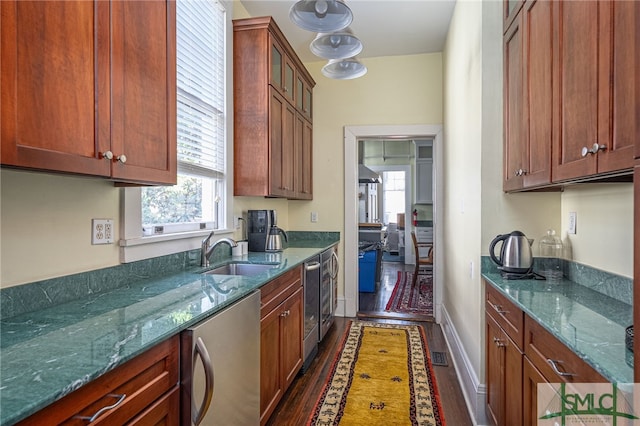 18 E 34th St, Savannah, GA 31401 - kitchen featuring dark wood-type flooring, a sink, dark stone countertops, and healthy amount of natural light