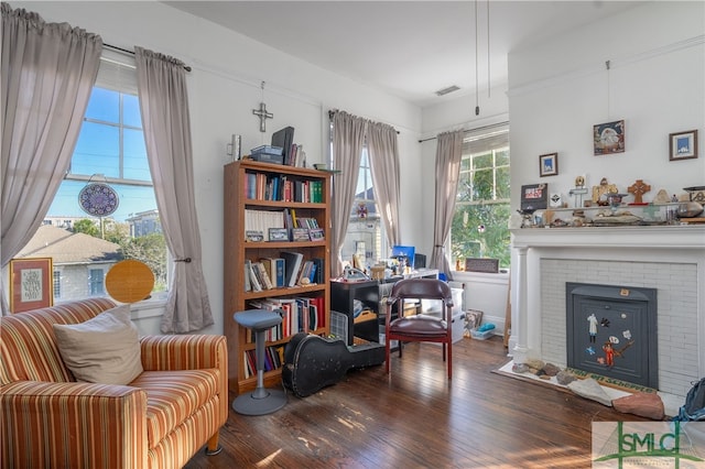 18 E 34th St, Savannah, GA 31401 - sitting room featuring wood finished floors and a brick fireplace