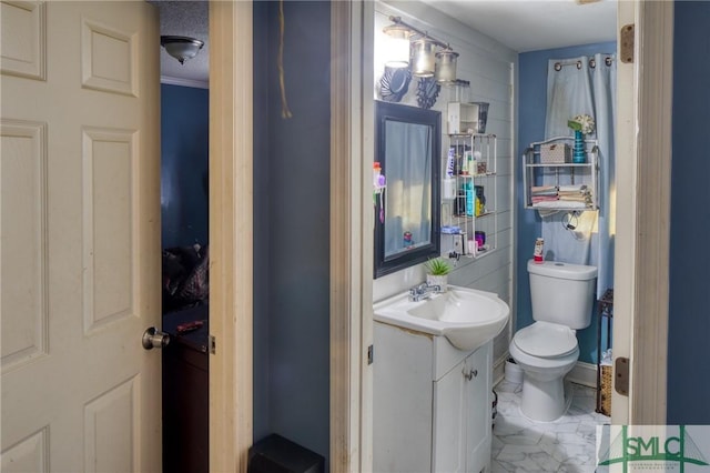 bathroom featuring vanity, a textured ceiling, ornamental molding, and toilet