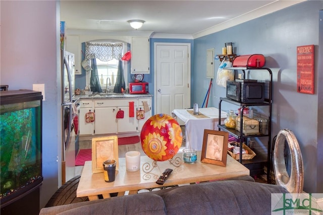 dining room featuring crown molding and sink