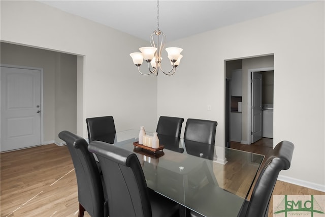 dining area with a chandelier and light hardwood / wood-style floors