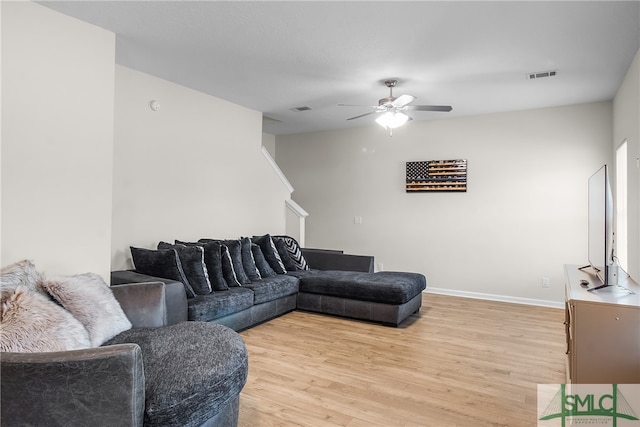 living room featuring light wood-type flooring and ceiling fan