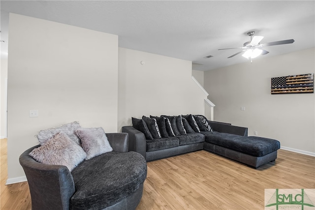 living room featuring ceiling fan and wood-type flooring