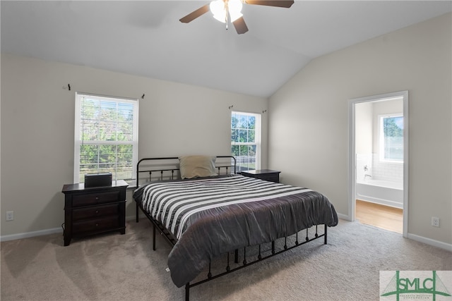 carpeted bedroom with ensuite bath, ceiling fan, and lofted ceiling