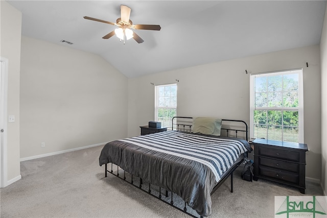 bedroom featuring light colored carpet, multiple windows, lofted ceiling, and ceiling fan