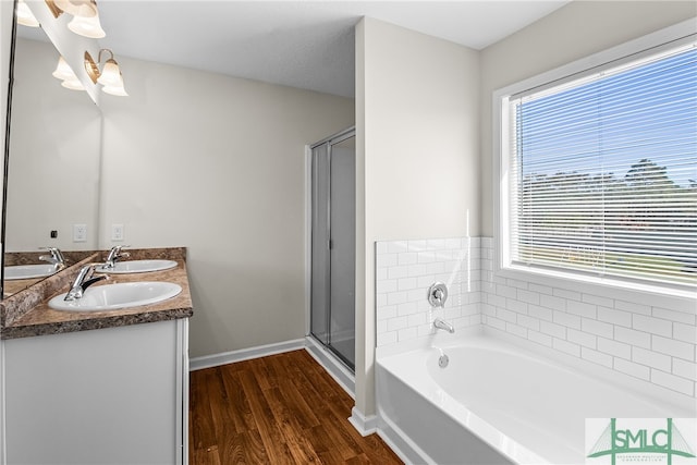 bathroom featuring a wealth of natural light, hardwood / wood-style floors, vanity, and independent shower and bath